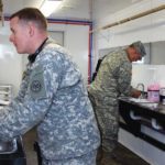 soldiers washing hands in sinks